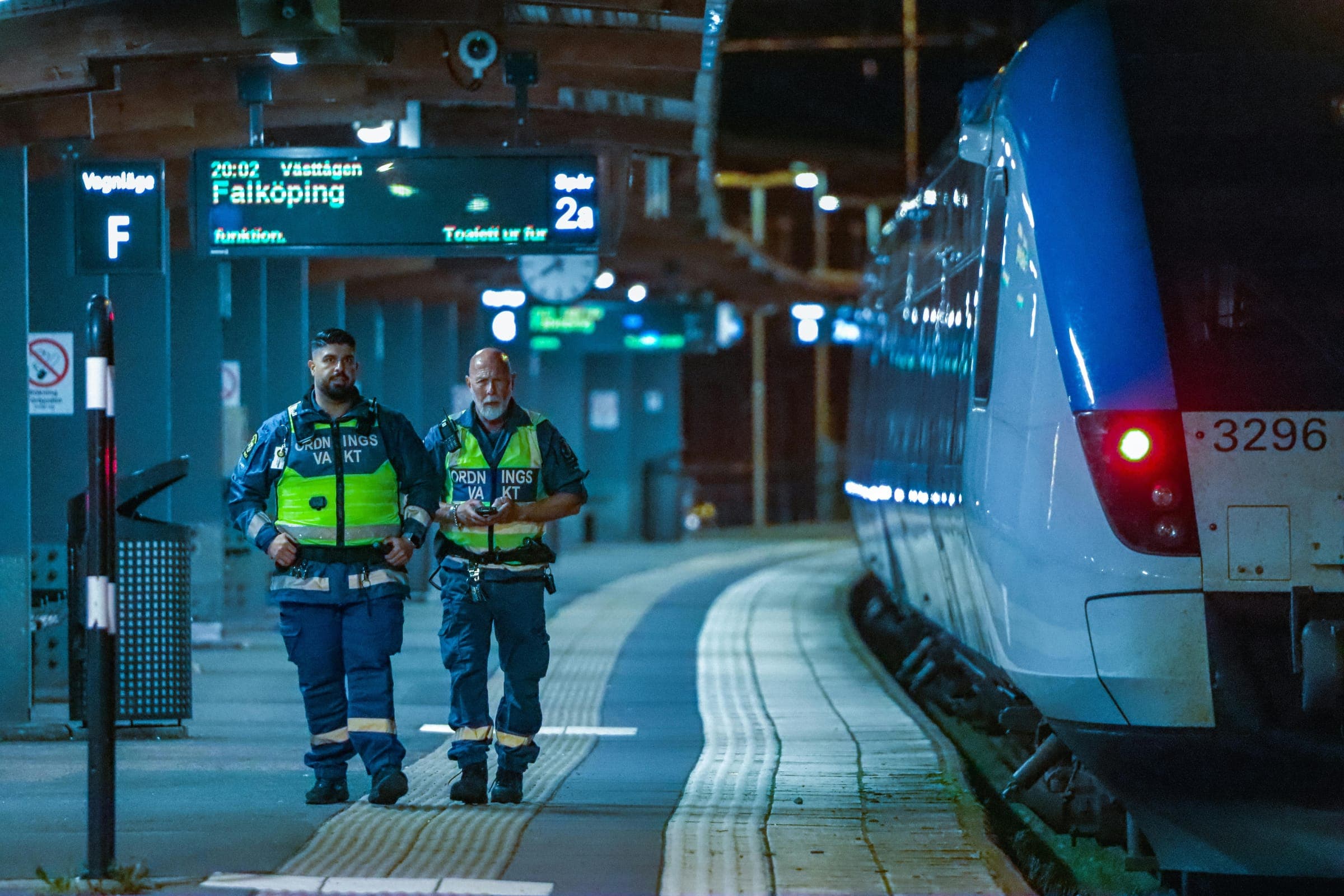 Two security officers patrolling a train platform